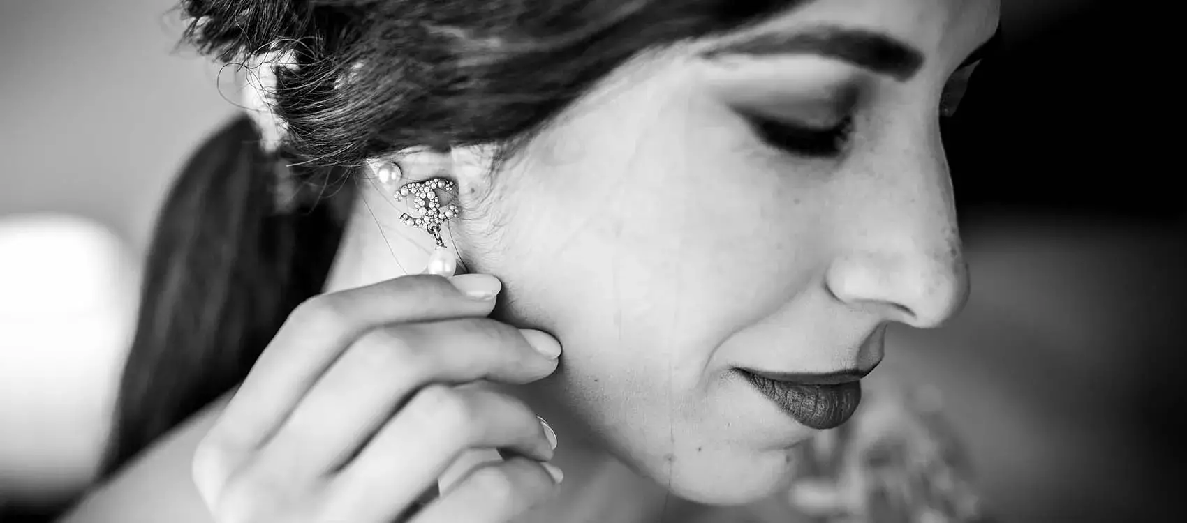 sposa che si mette gli orecchini di Chanel